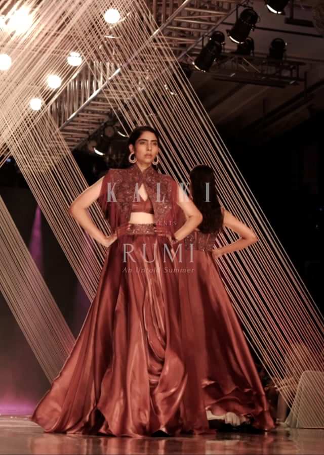 Cherry Organza Lehenga With A Crop Top In Sequins Embroidery, Crop Top Comes In Sleeveless In A V Neckline, Paired With The Matching Fringed Cape