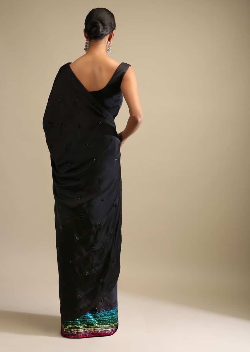 Black Saree In Satin Embellished With Multi Colored Kundan Work On The Border And Butti Work  