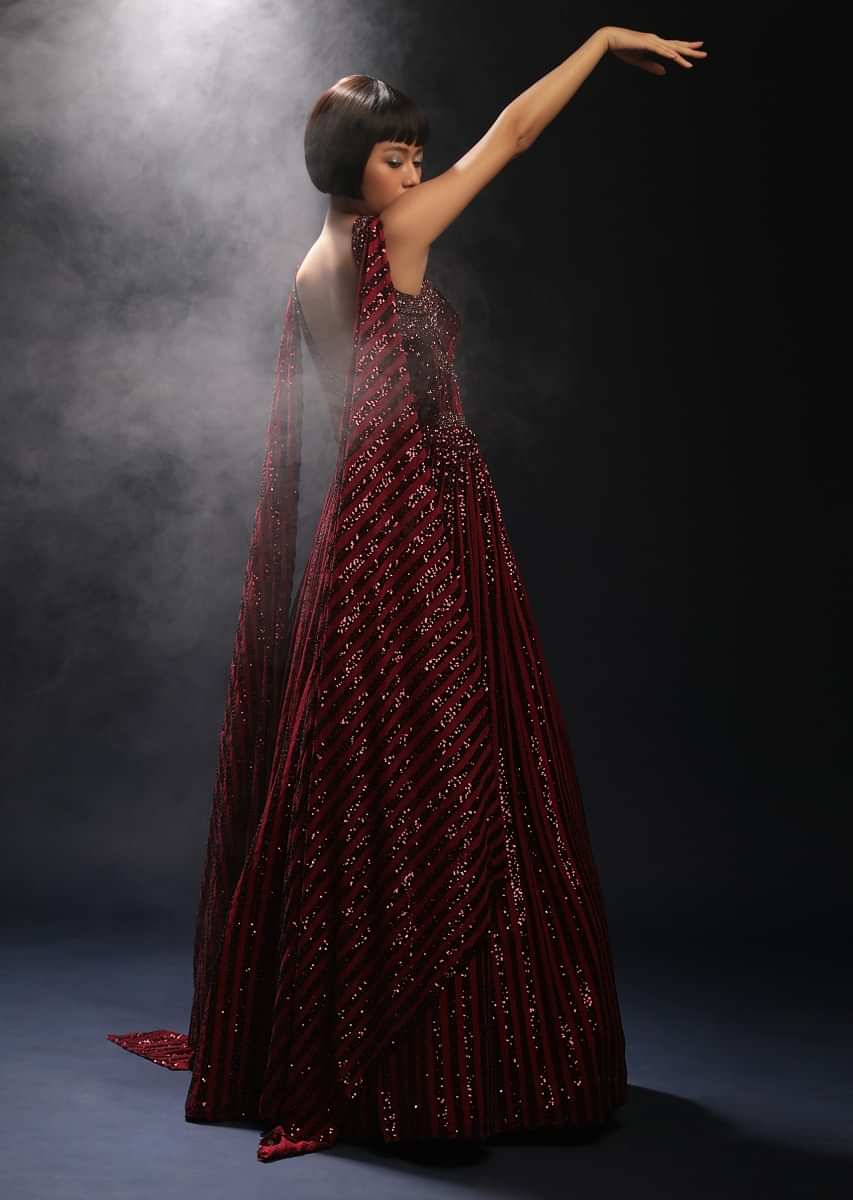 Burgundy Gown In Sequins Embellished Net With Attached Cape And Cut Dana Accented Front Cut Bodice