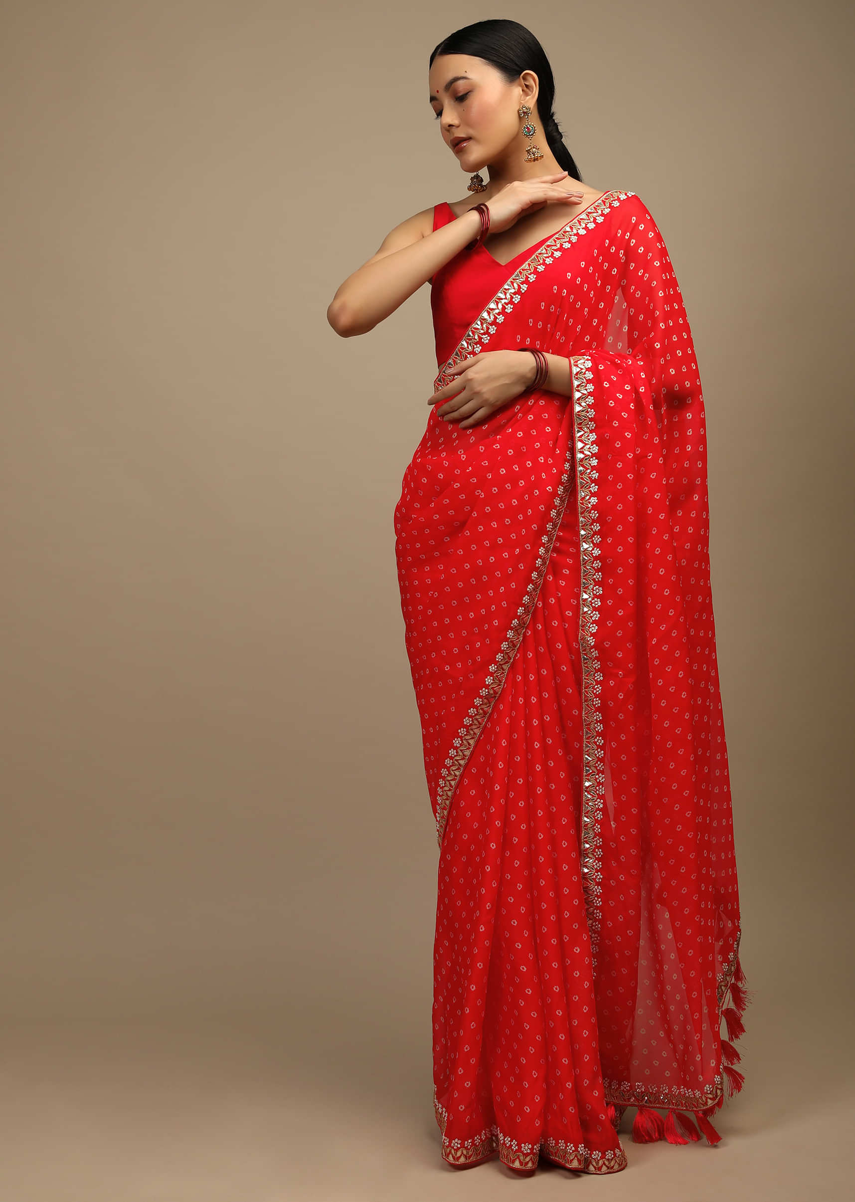 Coral Red Saree In Organza With Bandhani Buttis And Gotta Patti Embroidered Floral Motifs On The Border  