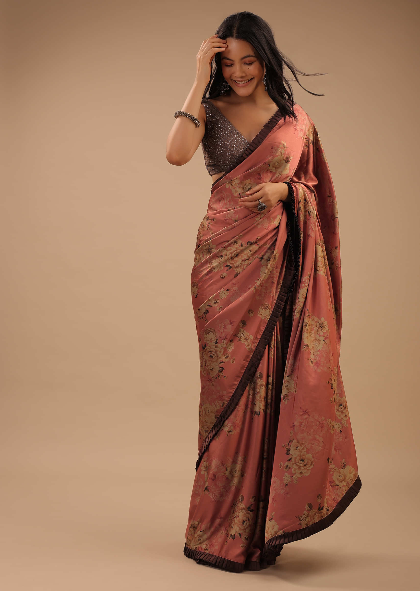 Coral Peach Saree With Brown Frill Borders And Floral Print