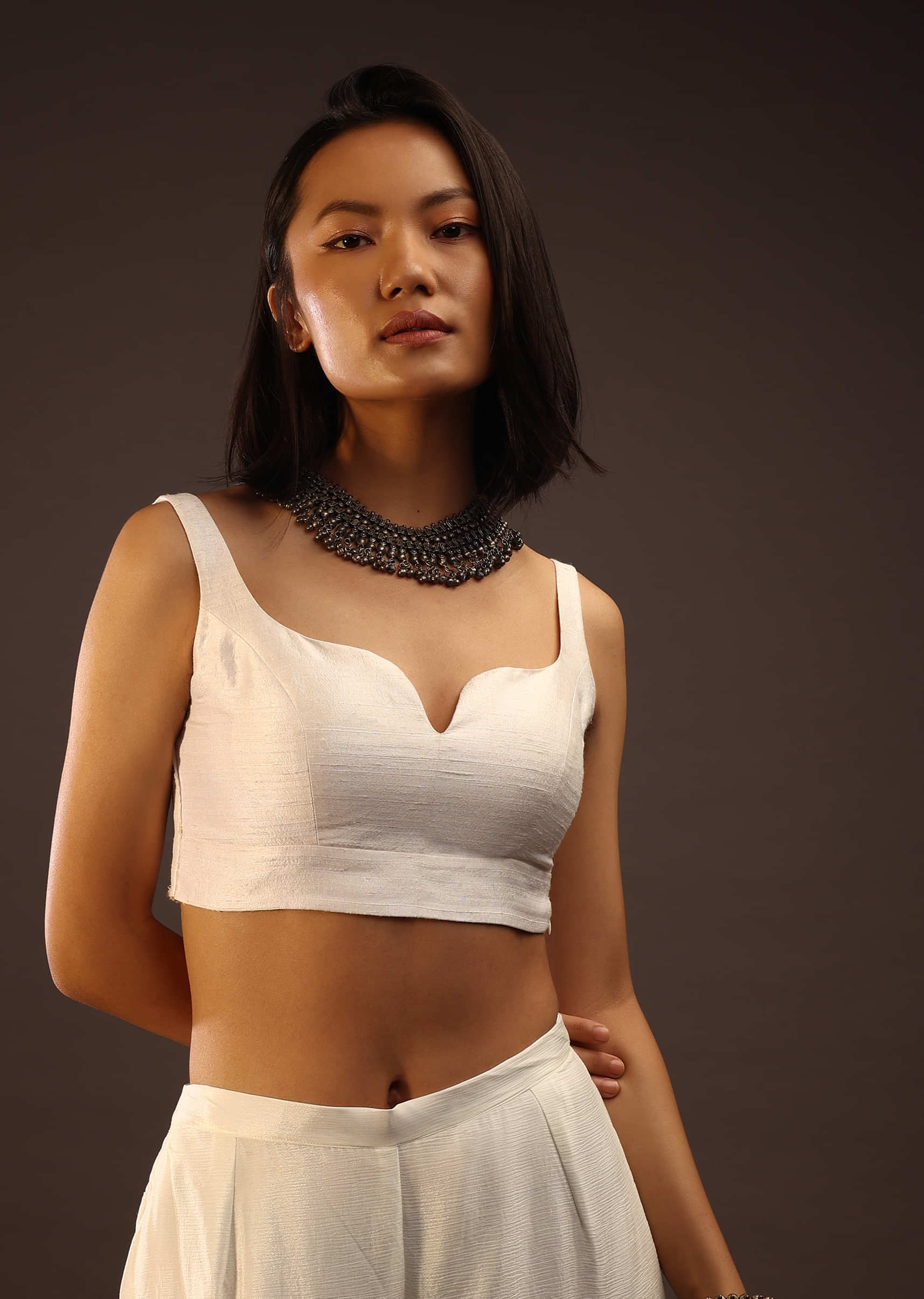 Egret White  Sleeveless Blouse With A Sweetheart Neckline. Padded With A Back Hook Closure
