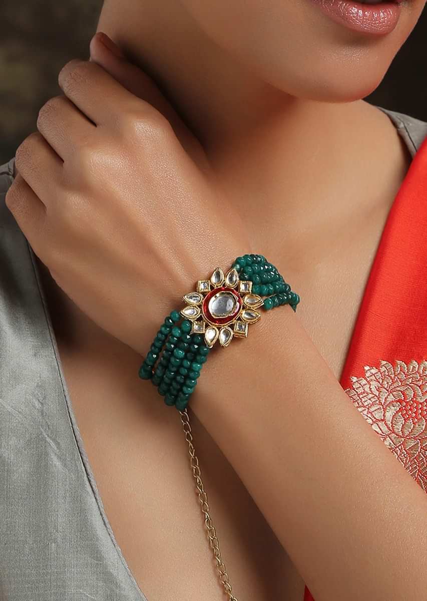 Gold Plated Kundan Bracelet With Emerald Green Stones Bead Strings And Mina Kari Detailing On The Edges By Paisley Pop
