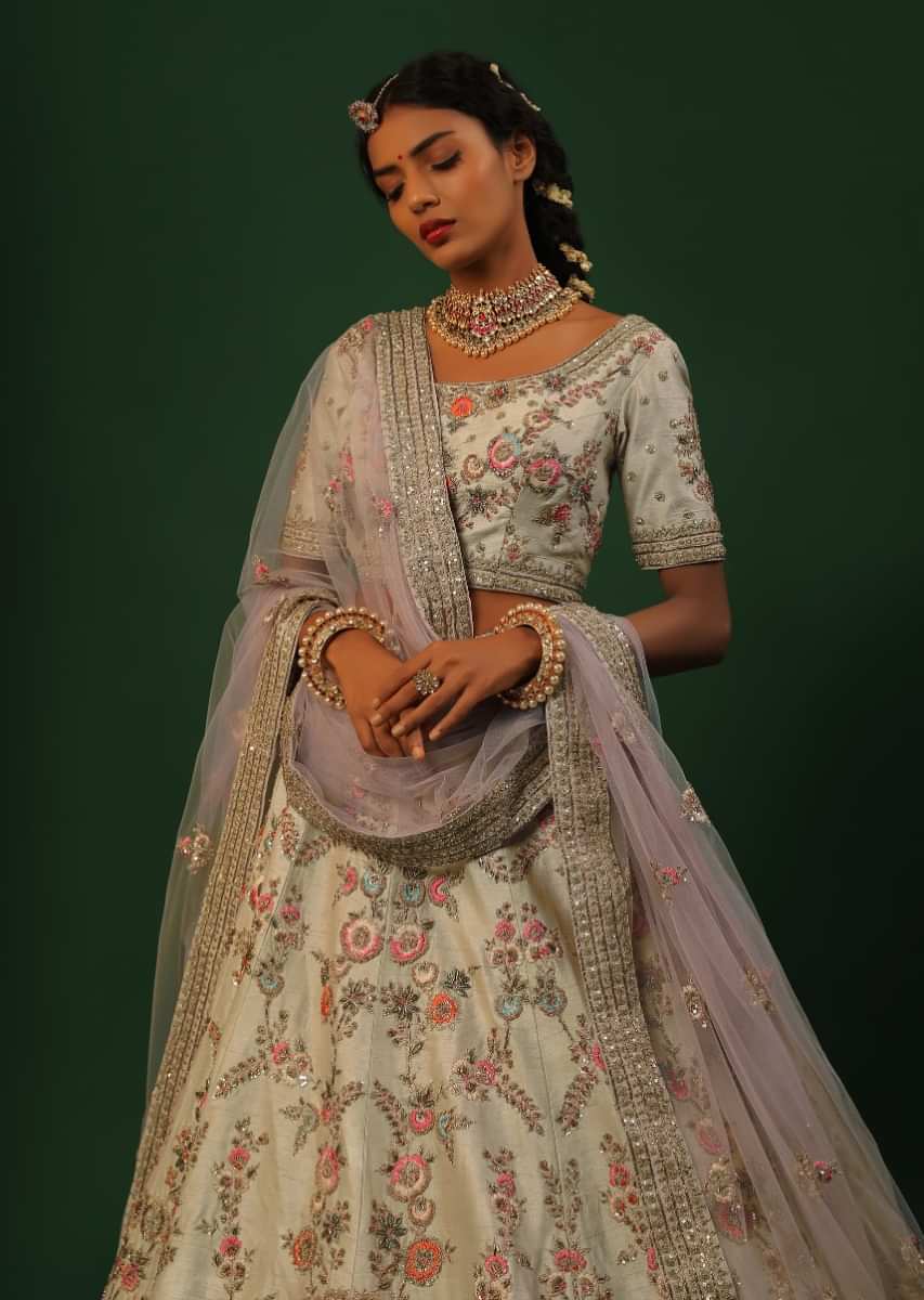 Ivory Lehenga Choli In Raw Silk With Colorful Resham And Golden Zardosi Embroidered Floral Jaal And Cut Work Border 