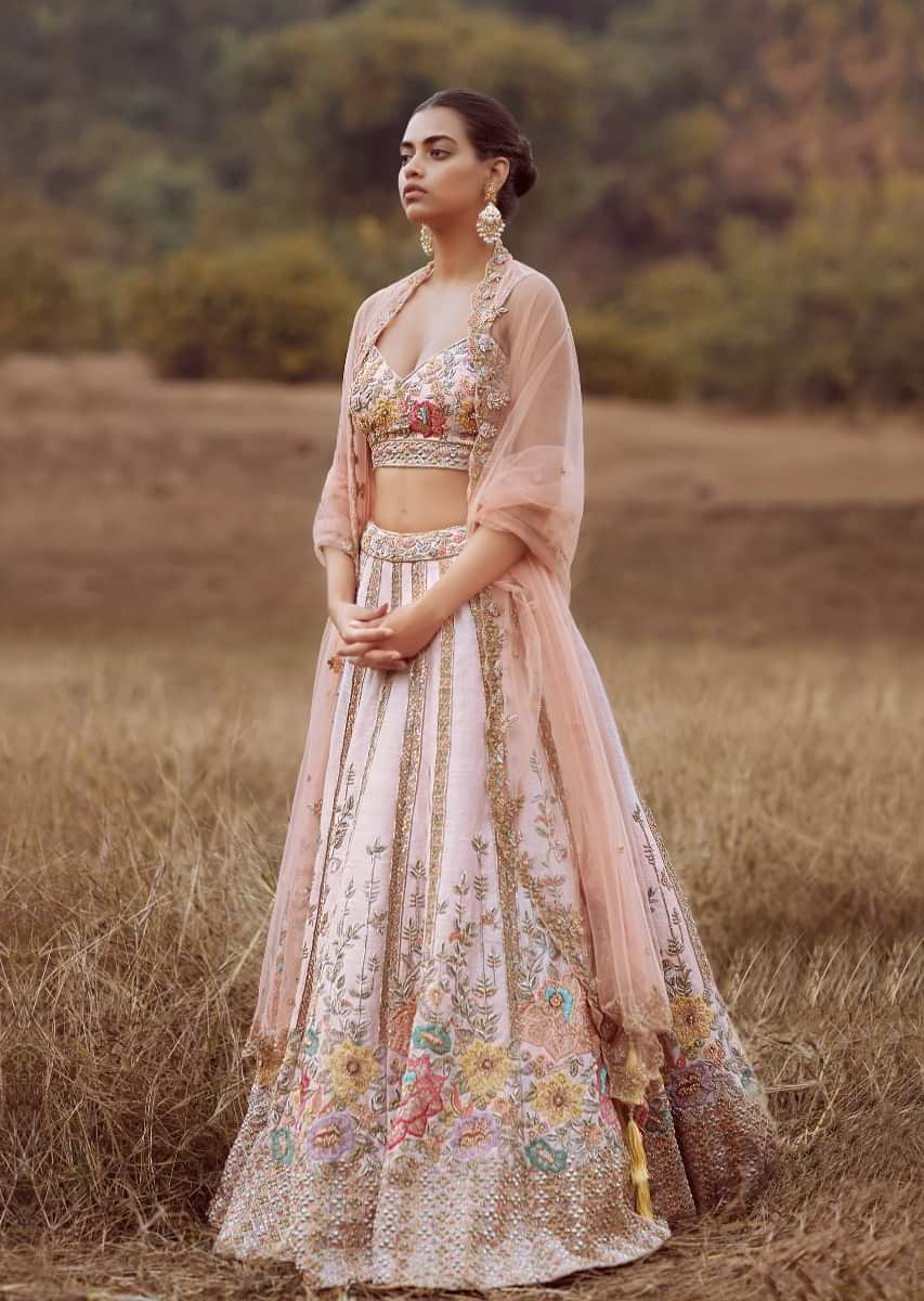 Ivory White Lehenga Choli In Raw Silk With Colorful Resham Flowers Along The Hemline And Vertical Embroidered Kali Detailing 