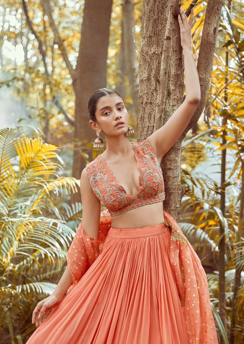 Fusion Coral Skirt In Crepe With Hand Embroidered Raw Silk Choli With Plunging Neckline 