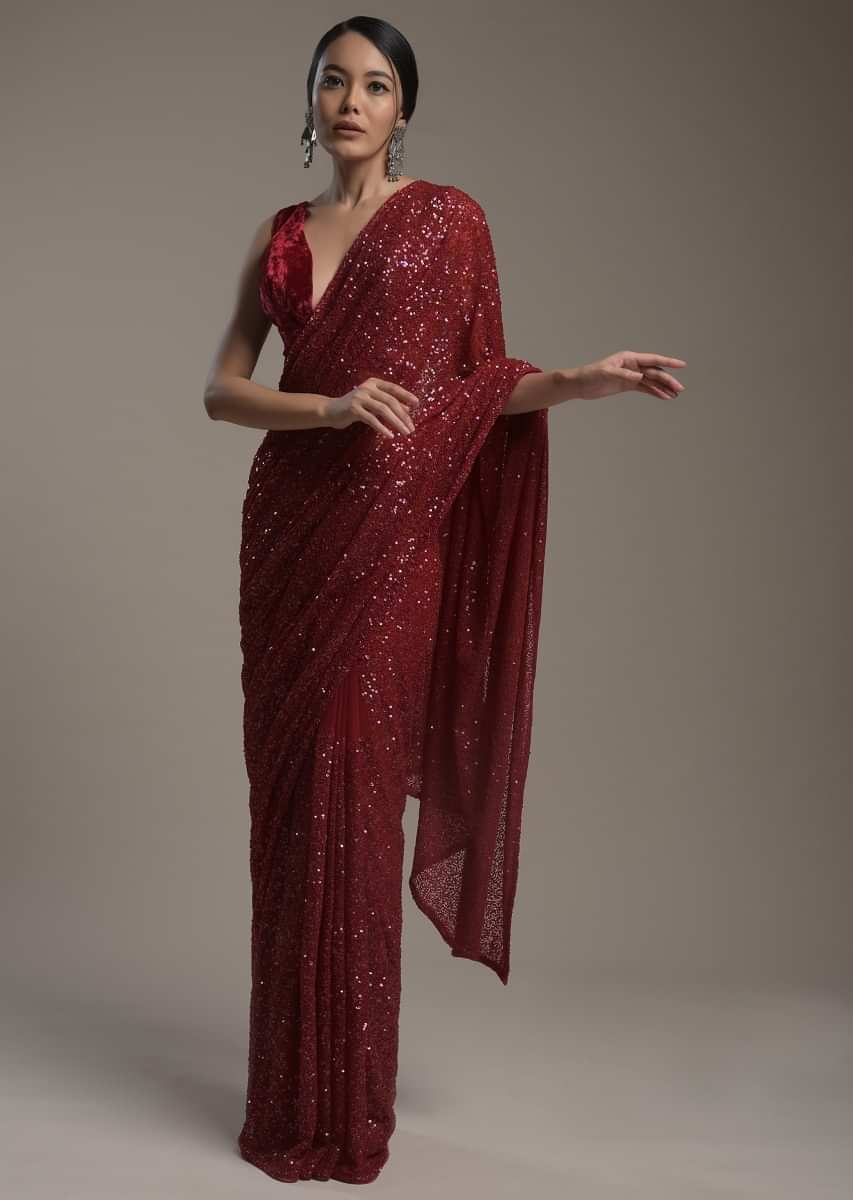 Maroon Saree In Net Heavily Embellished With Sequins And Paired With A Matching Unstitched Blouse