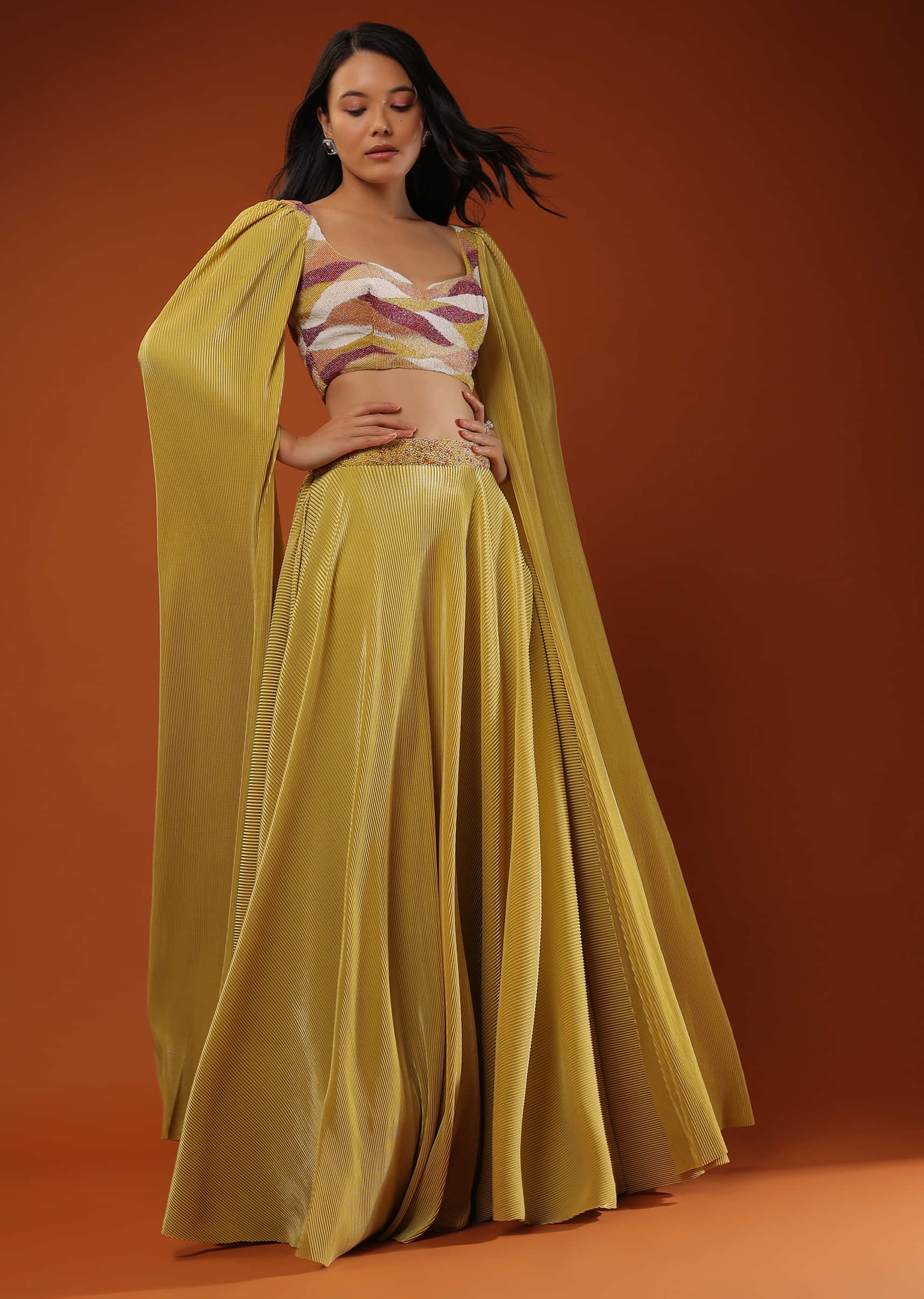Mustard Yellow Lehenga And Crop Top In Long Cape Sleeves, Crafted In Crush With A Side Zip Closure