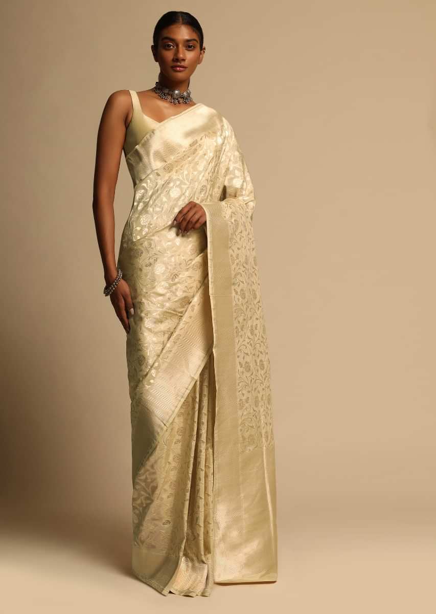 Beige Banarasi Saree In Pure Handloom Silk With Woven Floral Jaal And Floral And Checks Border Along With Unstitched Blouse Piece  