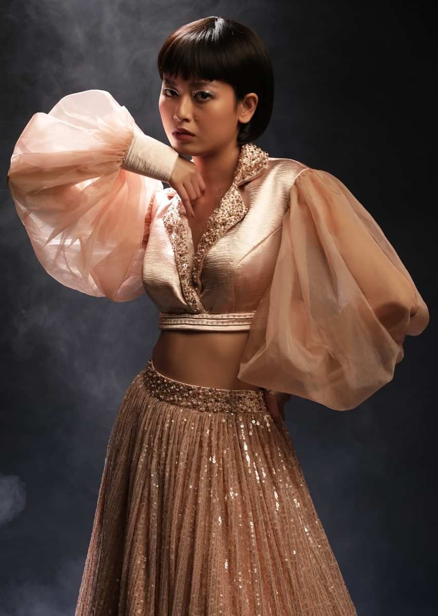 Peach Champagne Lehenga Embellished In Sequins And Velvet Crop Top Designed With Balloon Sleeves And Collar Neckline