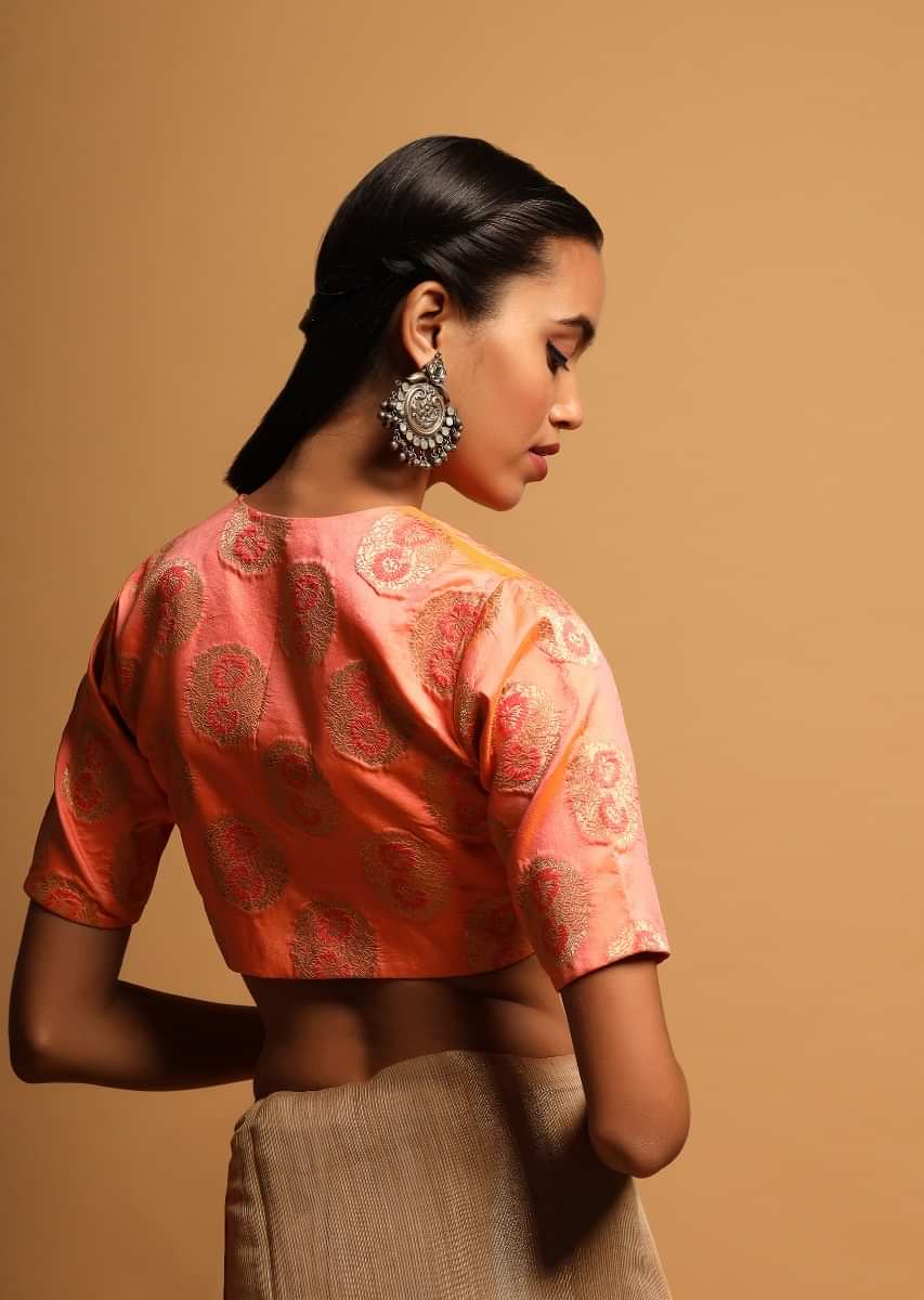 Peach Two Toned Blouse In Brocade Silk With Woven Floral Buttis And Curved Hemline