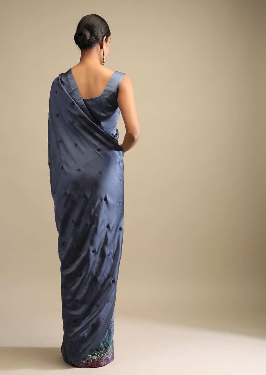 Pigeon Blue Saree In Satin Embellished With Multi Colored Kundan Work On The Border And Butti Work  