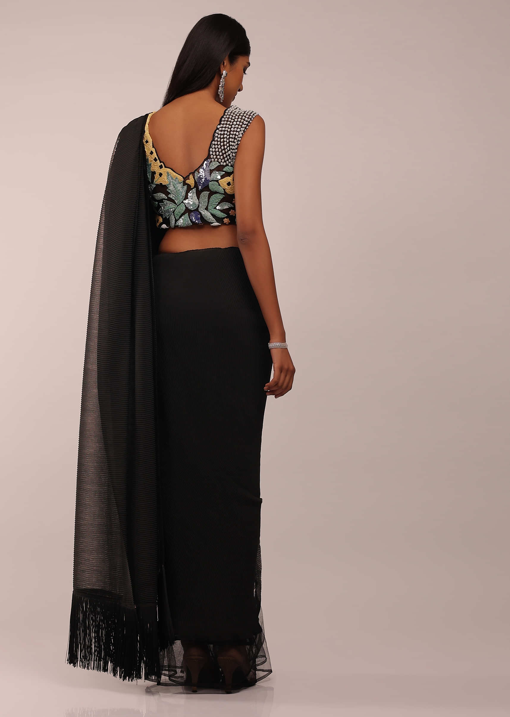 Pitch Black Crush Saree With Net Frills On The Bottom And Tassel Fringes On The Pallu Corner, Paired With A Sleeveless Blouse In Cut Dana And Moti Embroidery Buttis