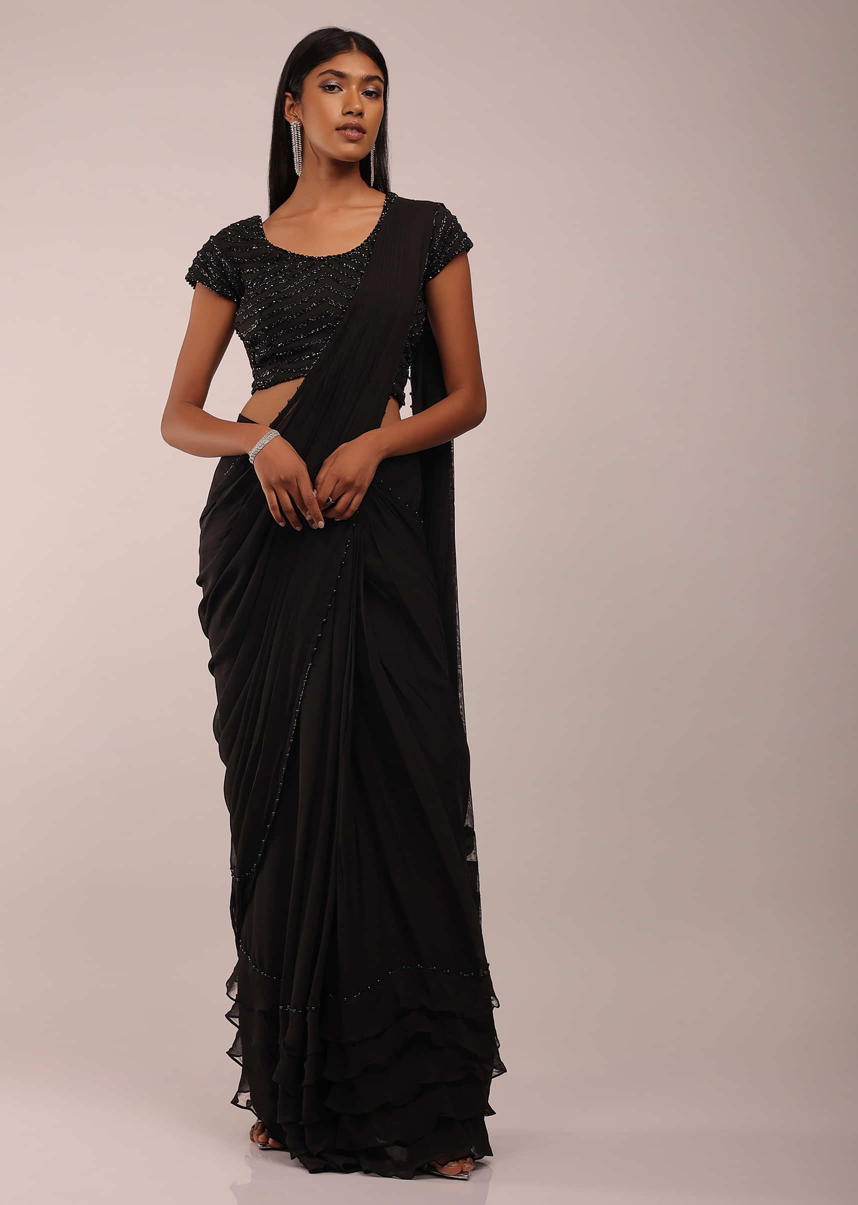 Pitch Black Saree With Three Tones Of Layered Frills On The Bottom Embellished In Stones And Sequins With A Tassel On The Pallu Corner