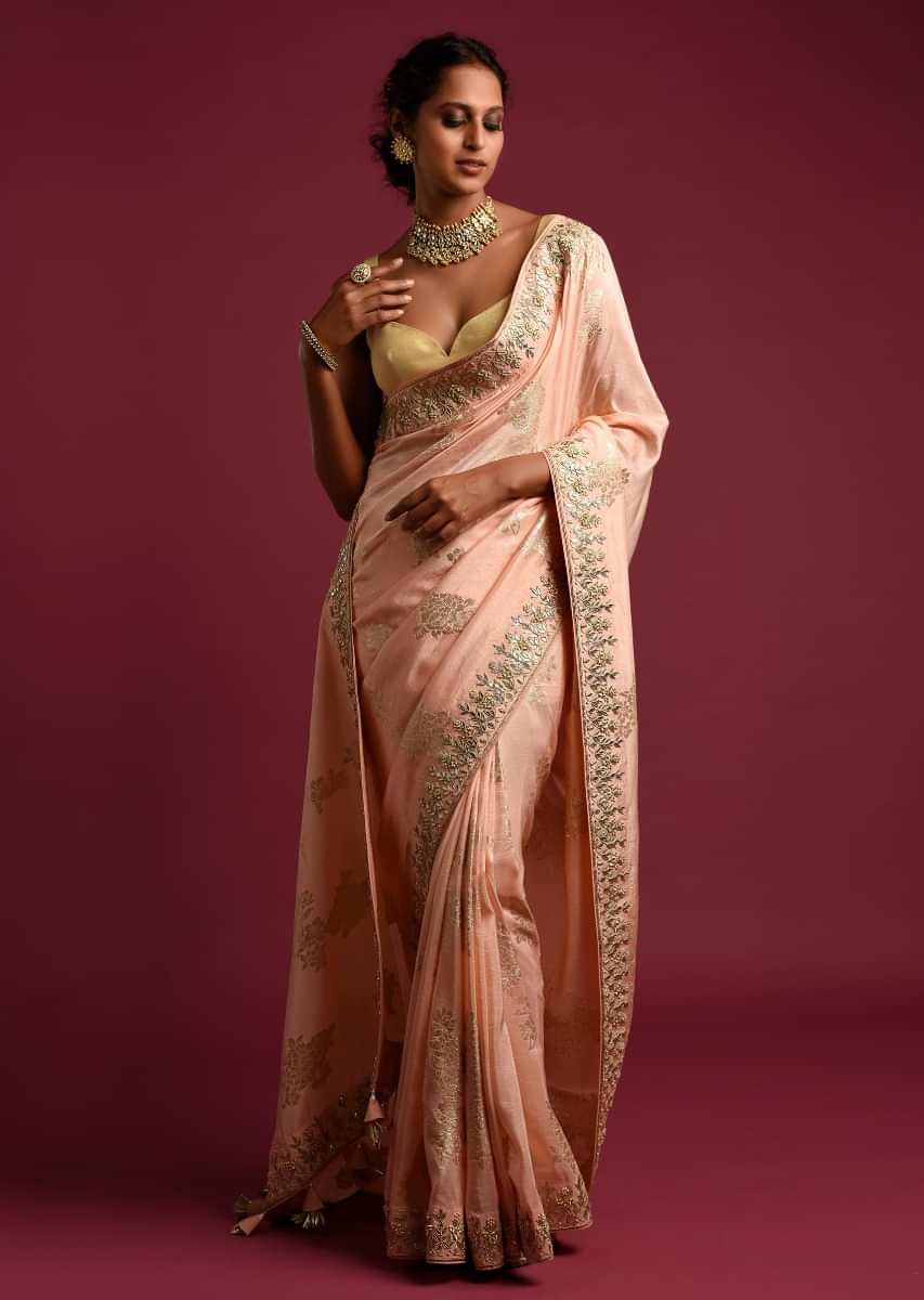 Powder Peach Banarasi Saree With Weaved Floral Motifs And Embroidered Border  