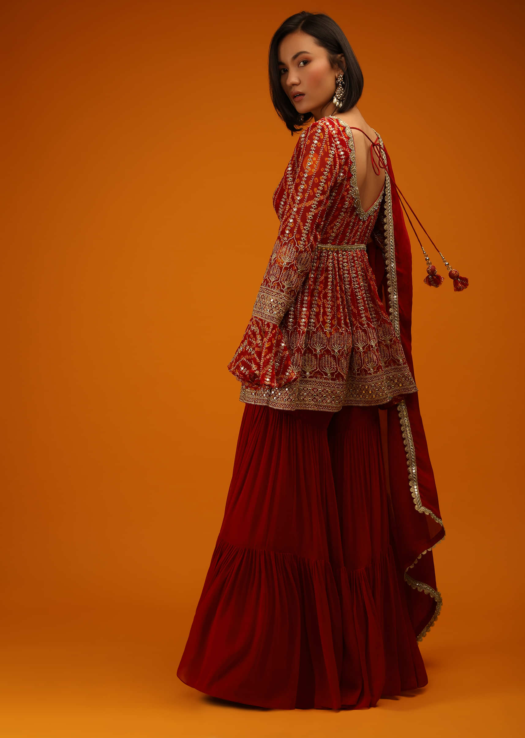 Red Sharara And Peplum Suit In Georgette With Bandhani Design, Mirror Work And Bell Sleeves