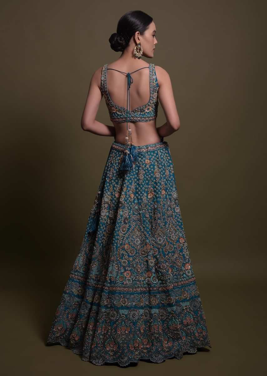 Teal Lehenga Choli In Raw Silk Hand Crafted With Embossed Embroidery In Heritage Floral Pattern 