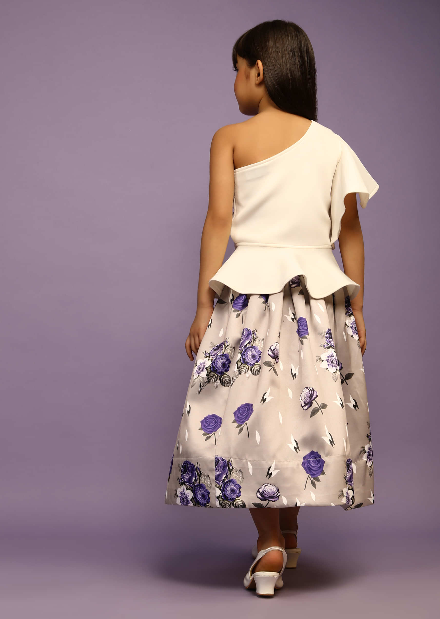 Kalki Girls White Peplum Top With One Shoulder Ruffle Sleeves And Grey Floral Printed Skirt  