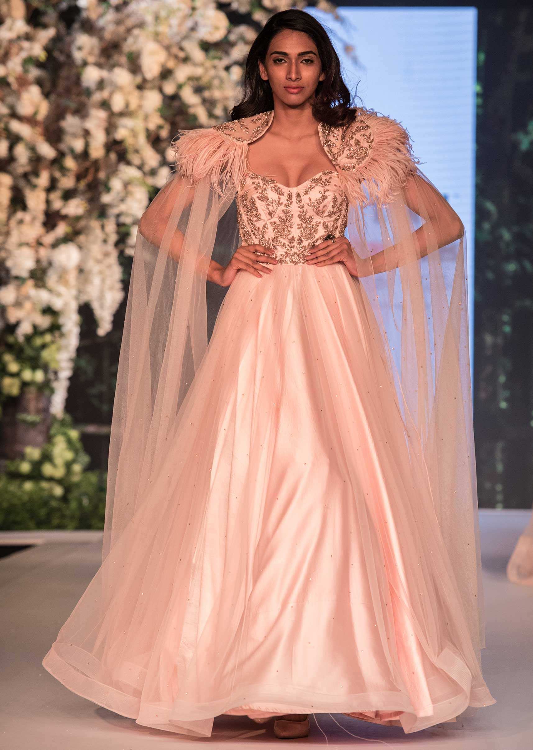 Ice Pink Corset Gown In Net With Fancy Cape Highlighted In Feathers Online - Kalki Fashion