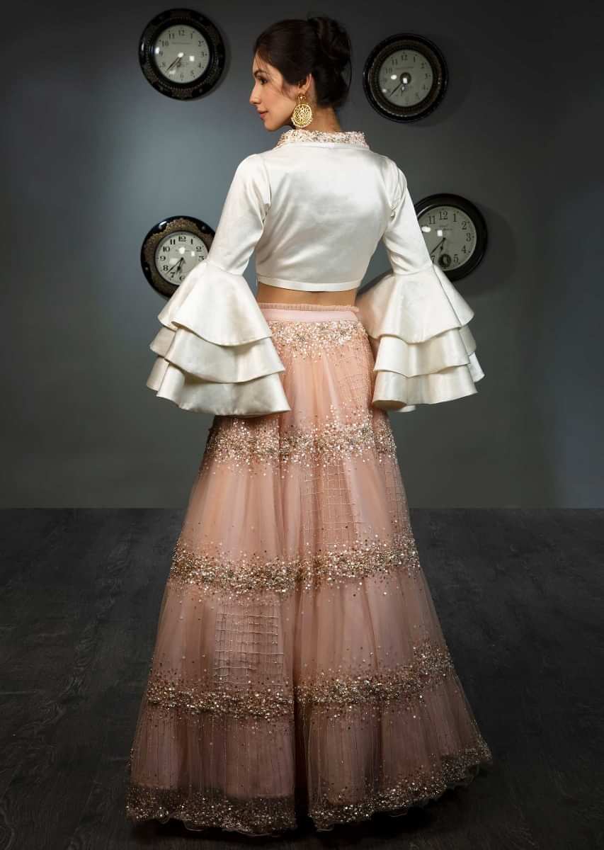White Blouse In Satin With Layered Frill Sleeves Paired With Peach Net Skirt In Moti And Sequins Embroidery Online - Kalki Fashion