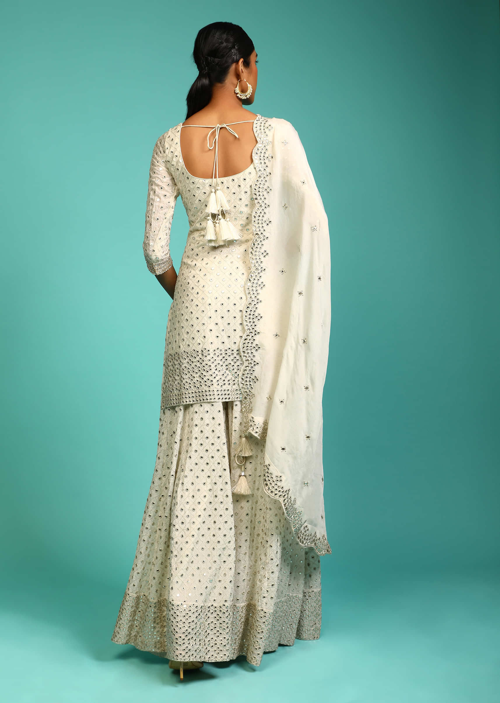 Powder White Palazzo Suit In Crepe With Zari And Mirror Embroidered Geometric Jaal Along With Heavy Border Design  