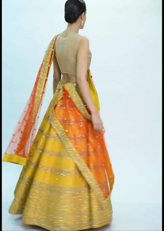 Chrome yellow raw silk lehenga with orange net dupatta only on kalki