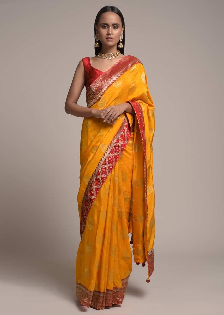 Amber Yellow Saree In Dola Silk With Brocade Leaf Shaped Buttis And Contrast Red Bandhani Border