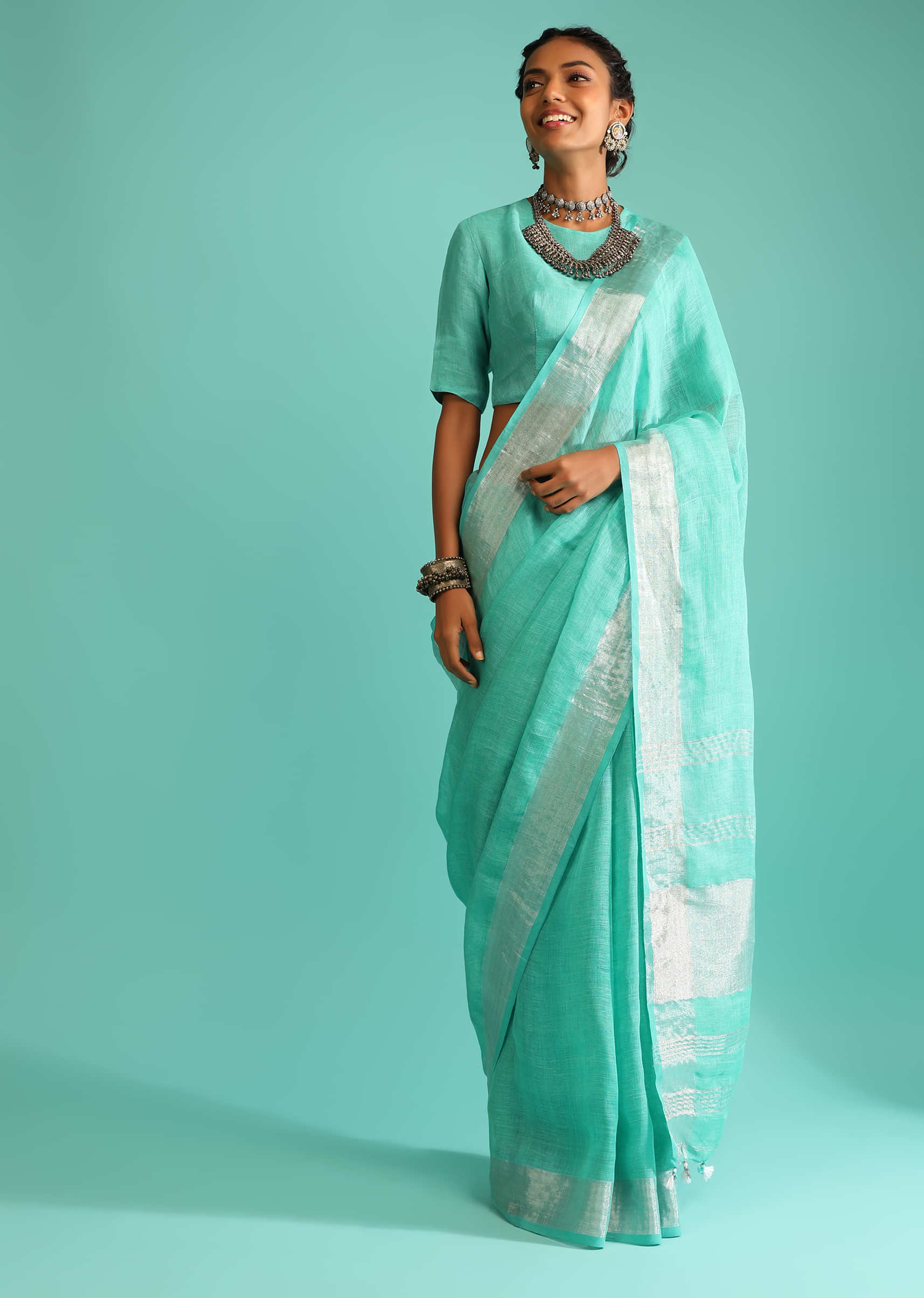 Aqua Green Saree In Linen With Silver Brocade Border And Striped Pallu Along With A Matching Unstitched Blouse  