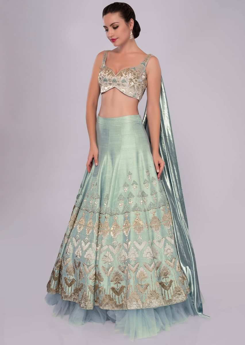 Aqua blue raw silk lehenga set with Greek inspired cowl drape at the back of the blouse only on Kalki