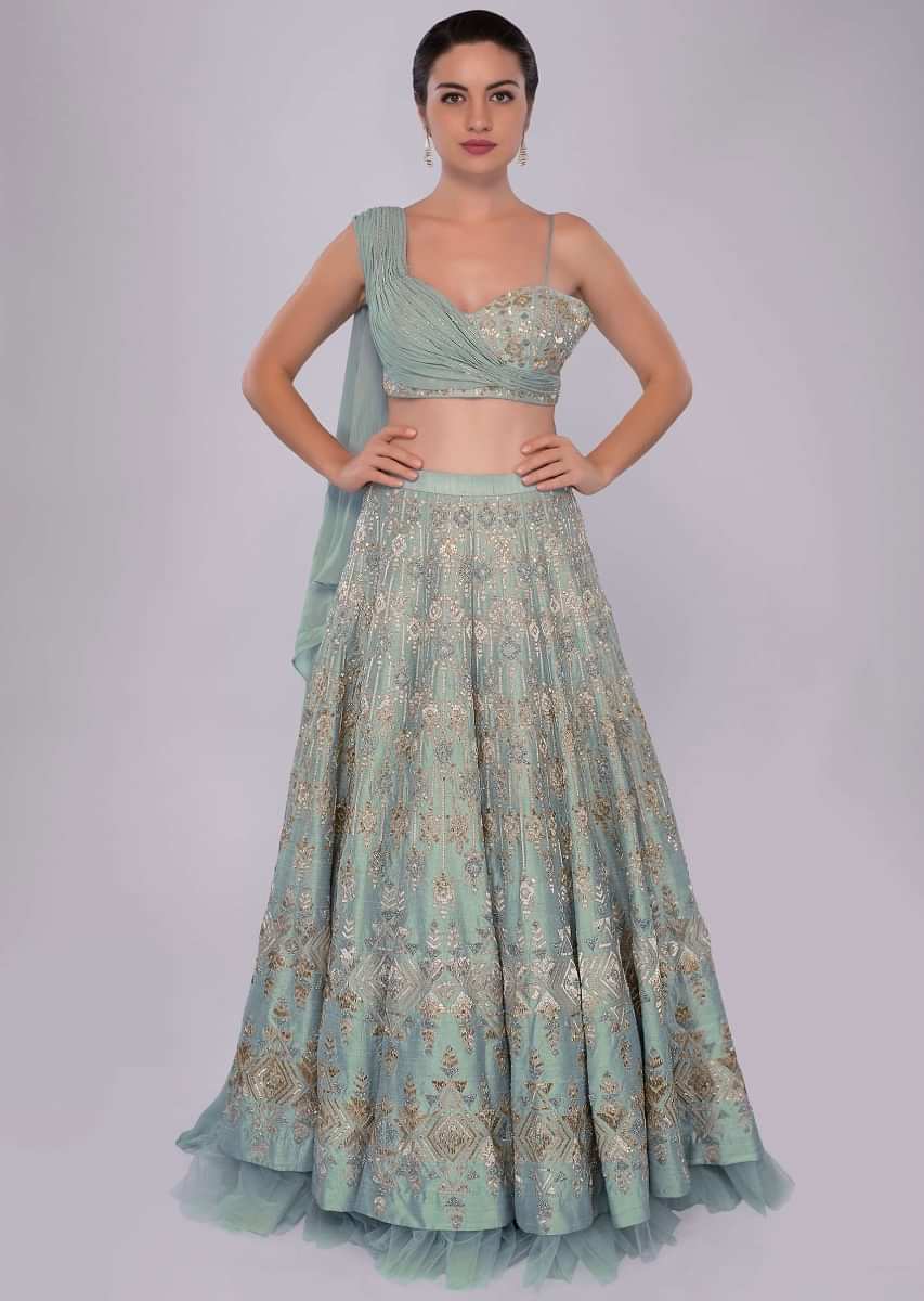 Aqua time blue raw silk lehenga teamed with one side strap bustier with georgette drape