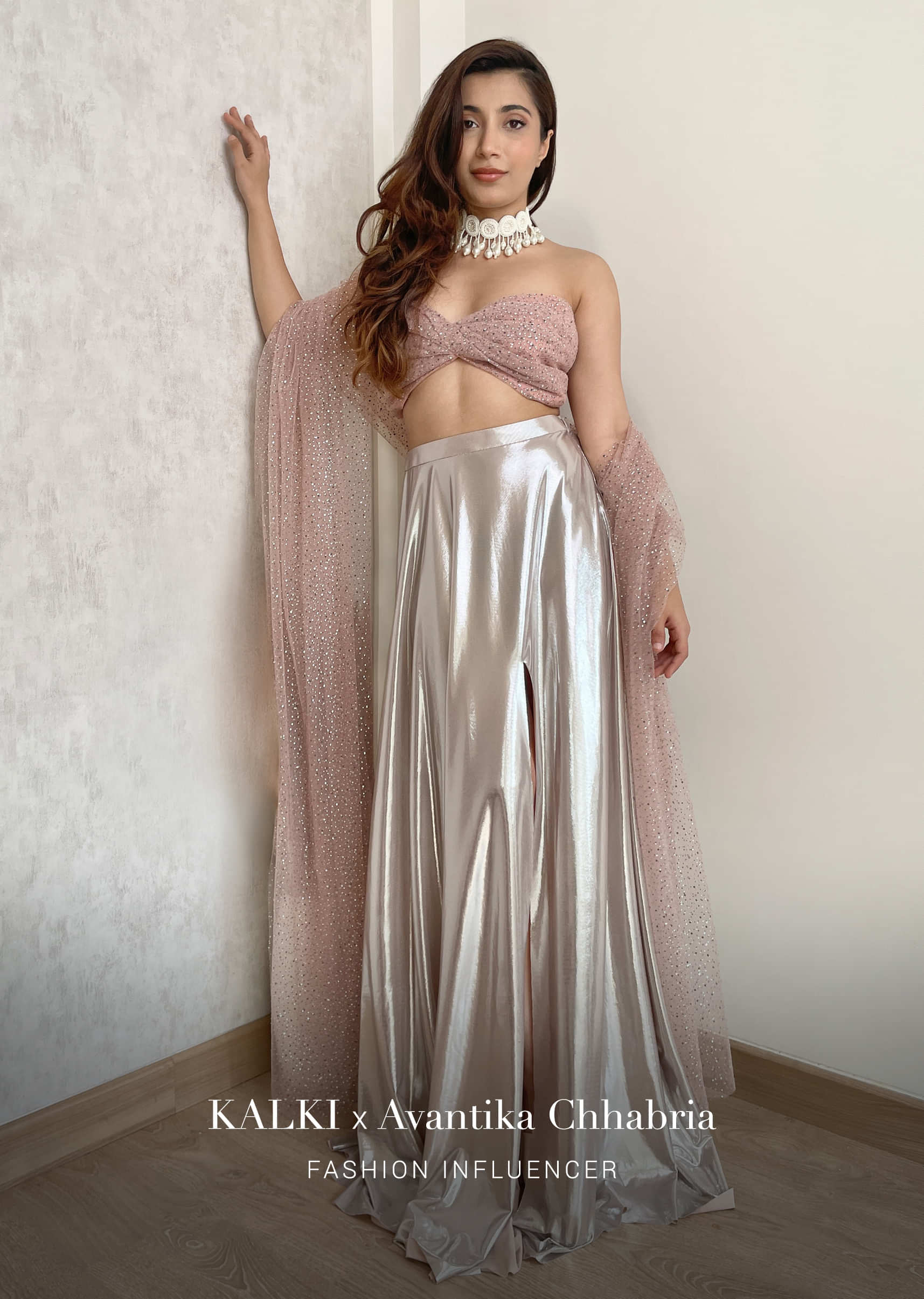 Ice Pink Skirt In Metallic Lycra With A Long Slit And Twisted Bandeau Top Embellished In Kundan