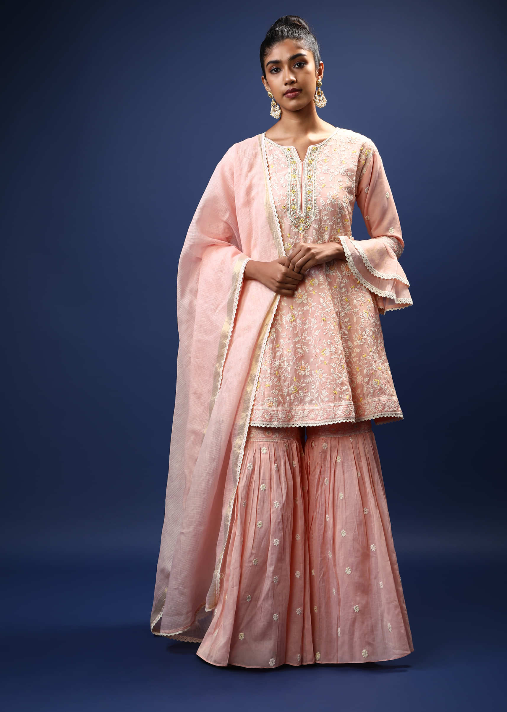 Baby Pink Sharara Peplum Suit In Cotton With Pastel And White Thread Embroidered Floral Motifs And Ruffle Sleeves  