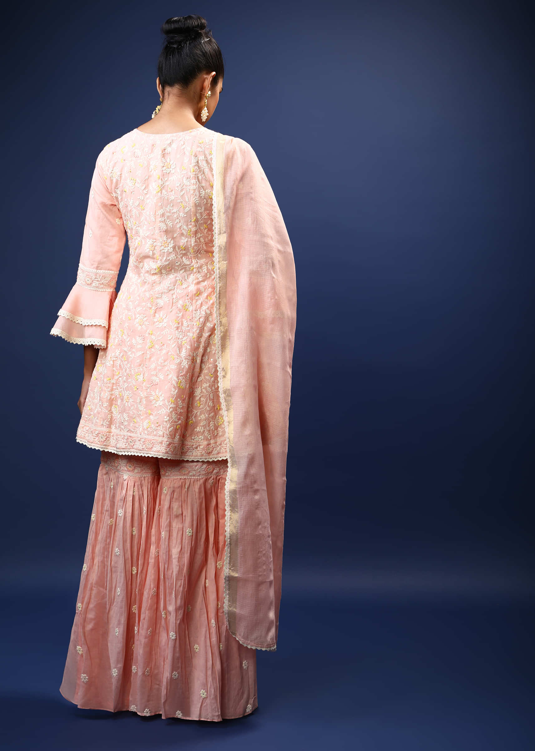 Baby Pink Sharara Peplum Suit In Cotton With Pastel And White Thread Embroidered Floral Motifs And Ruffle Sleeves  