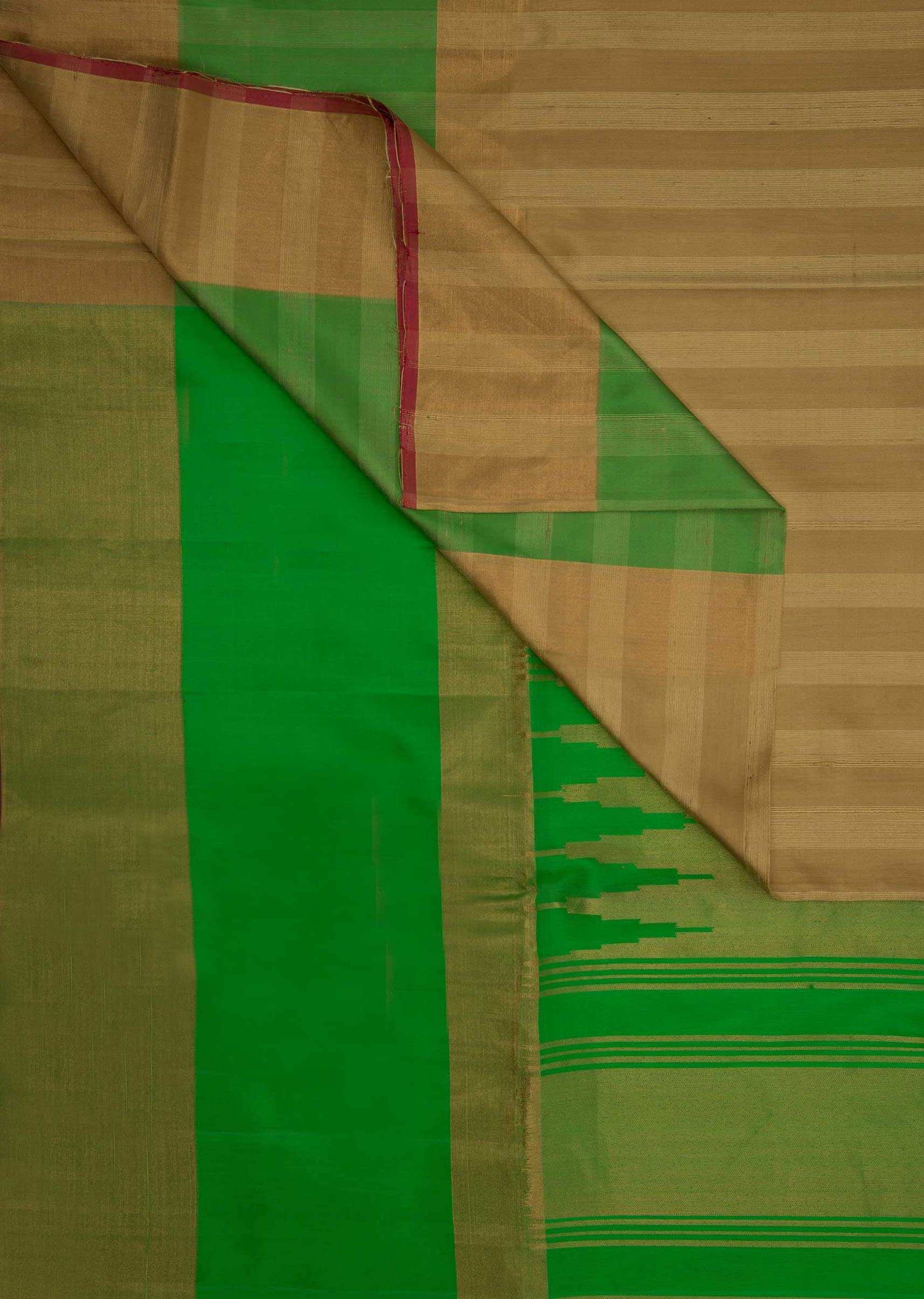 Beige silk plain saree with green brocade pallo