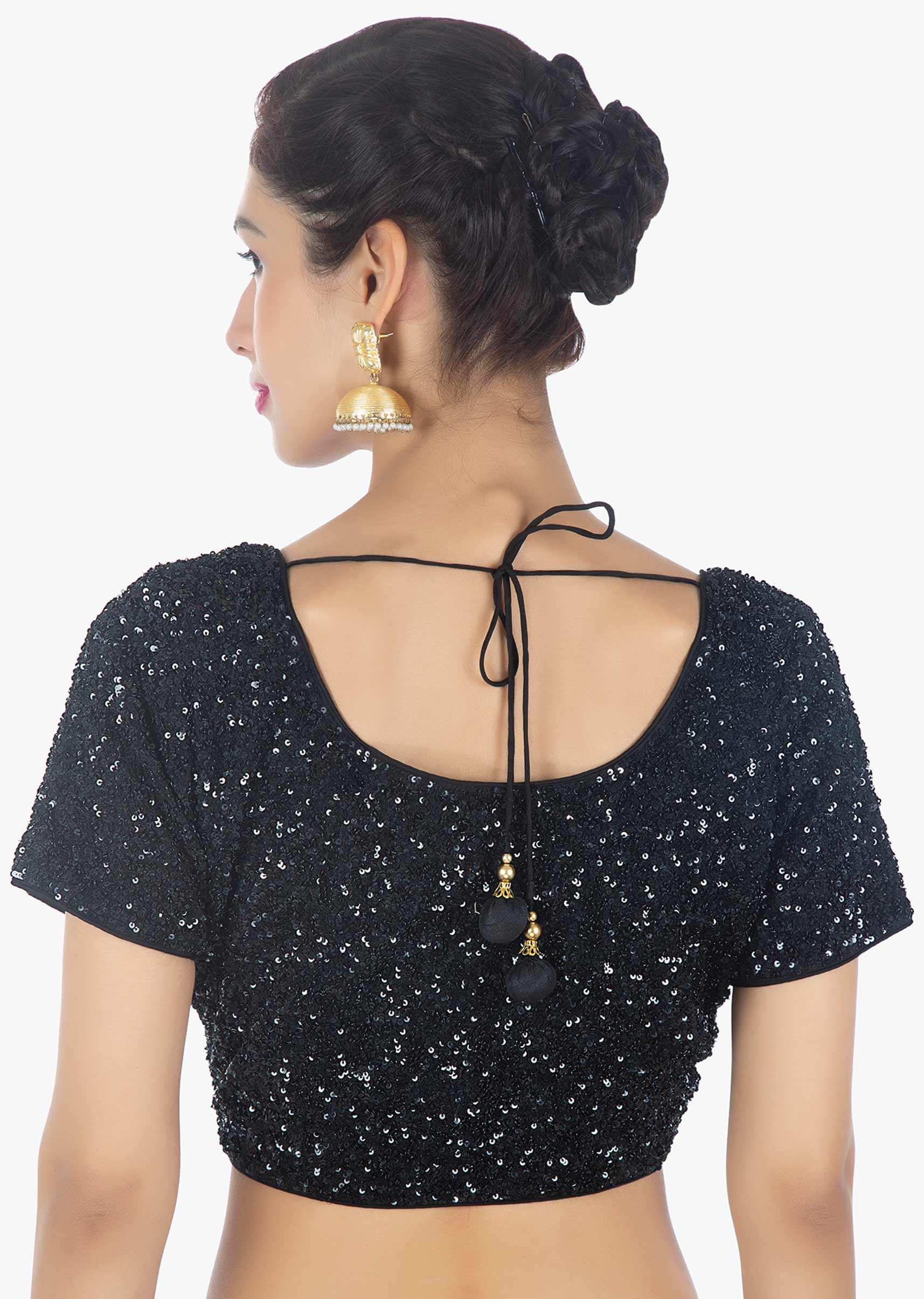 Black net thread embroidered saree paired with a shimmery sequins blouse