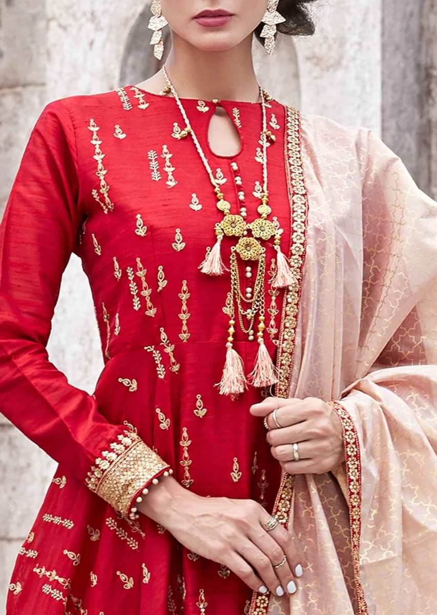 Blood red anarkali suit in raw silk with thread and zari embroidered butti all over