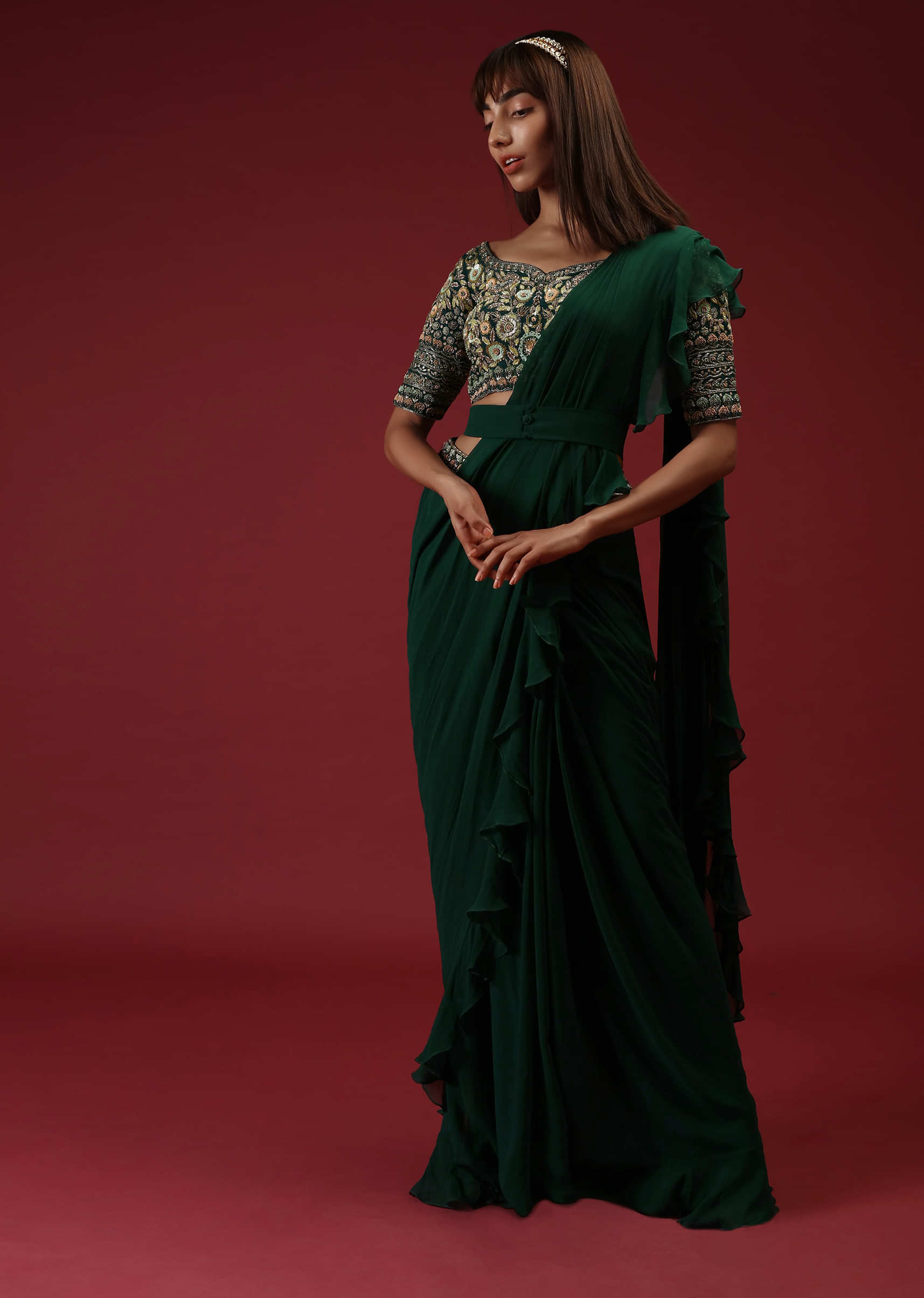 Bottle Green Ready Pleated Ruffle Saree With A Multi Colored Hand Embroidered Blouse And Plain Belt  