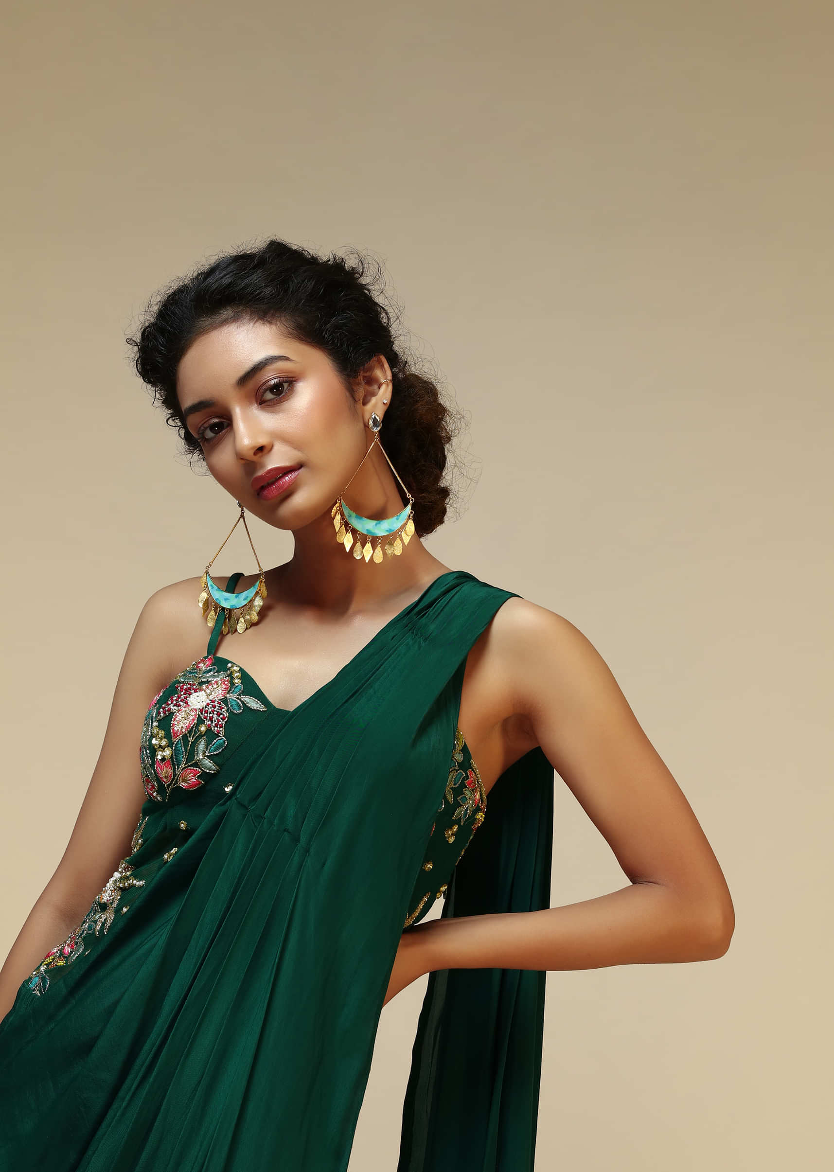 Bottle Green Saree Gown With A Crepe Cowl Drape And Sheer Embroidered Net Bodice With Colorful Resham Flowers  