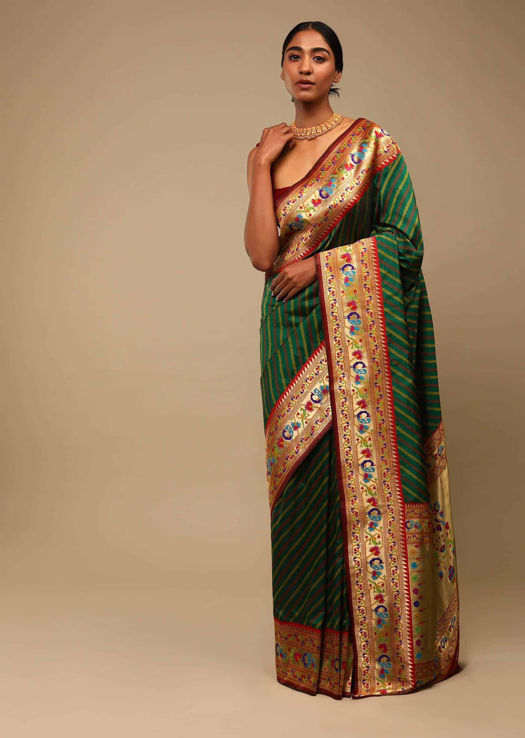 Bottle Green Saree In Art Handloom Silk With Woven Multi Colored Peacock Motifs On The Border, Diagonal Stripes And Unstitched Blouse  
