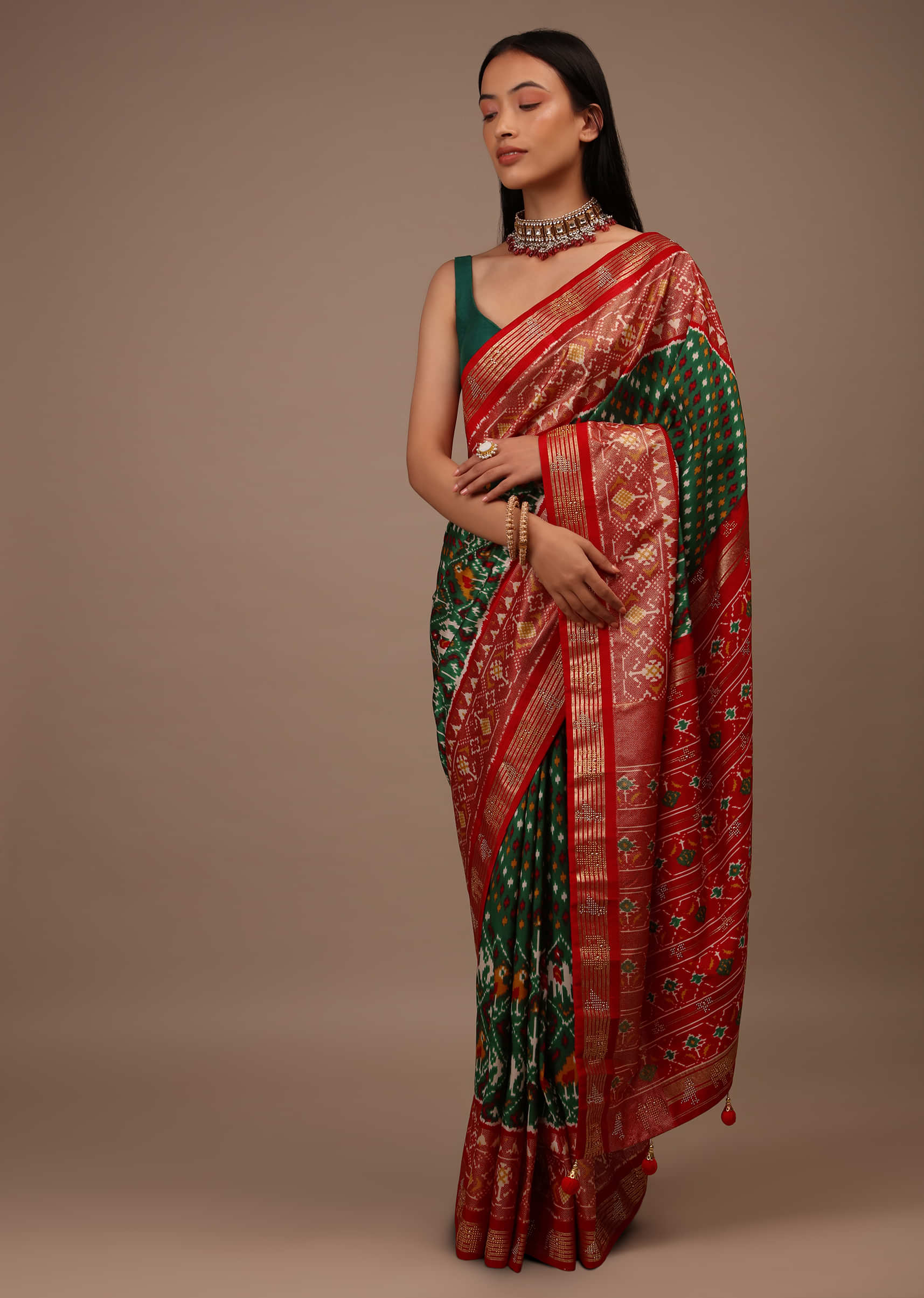 Bottle Green Saree In Silk With Multi Colored Patola And Foil Print And Contrasting Red Border