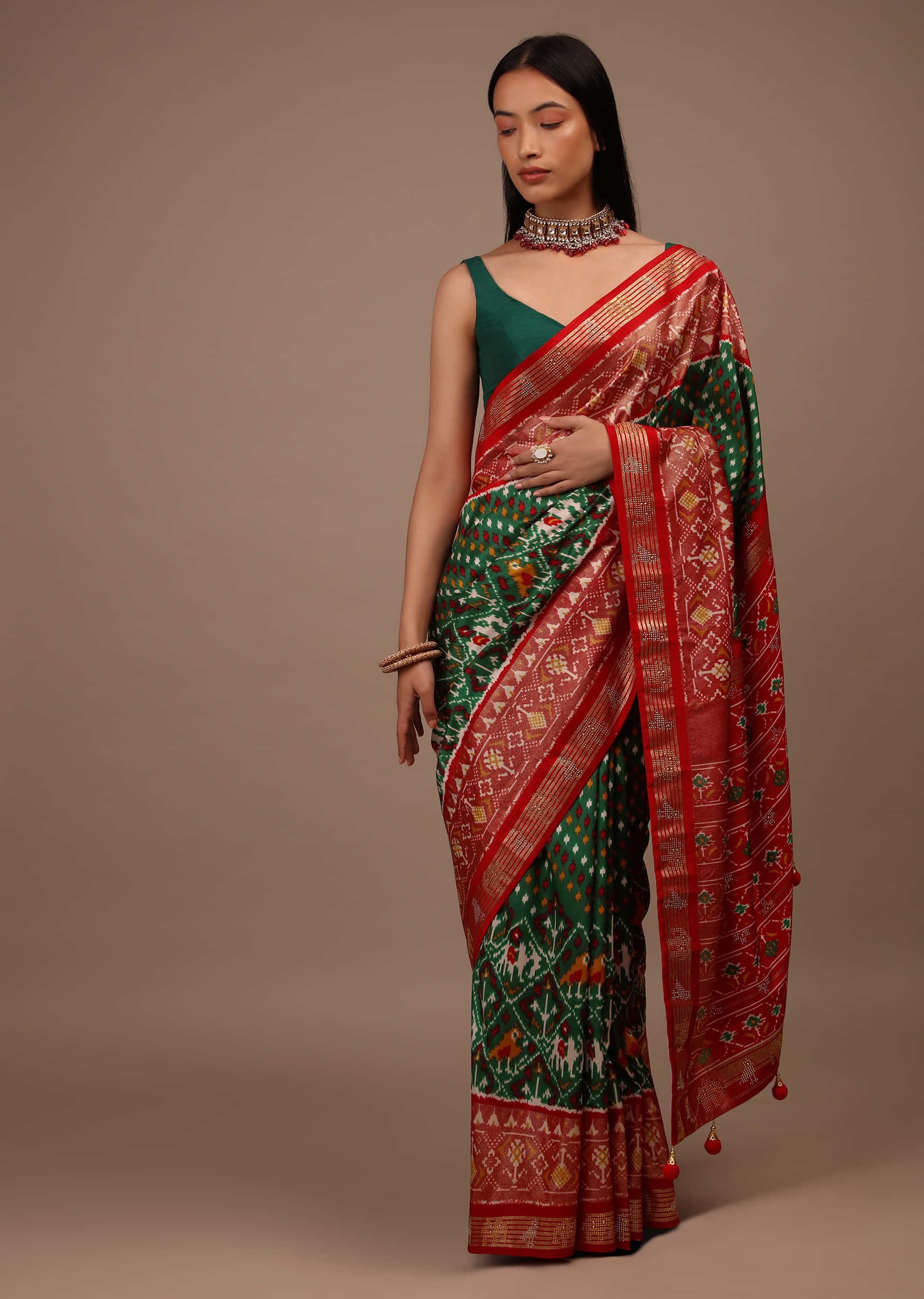 Bottle Green Saree In Silk With Multi Colored Patola And Foil Print And Contrasting Red Border