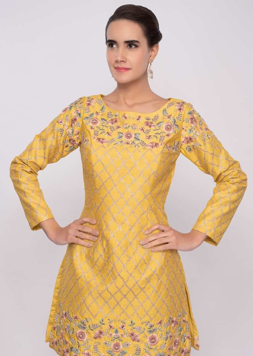Bright yellow sharara suit in multi color floral embroidery along with lace work only on Kalki
