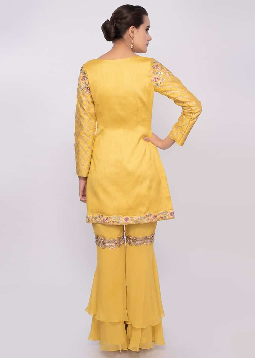 Bright yellow sharara suit in multi color floral embroidery along with lace work only on Kalki