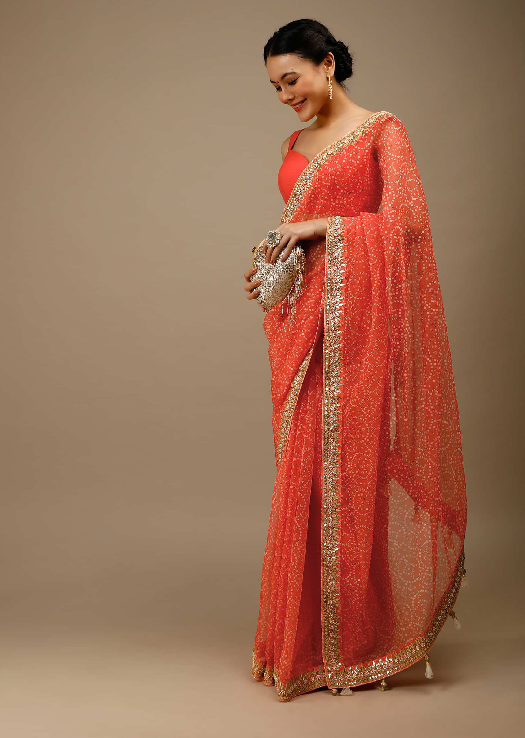 Camelia Orange Saree In Organza With Bandhani Jaal And Gotta Patti Embroidered Floral Motifs On The Border  