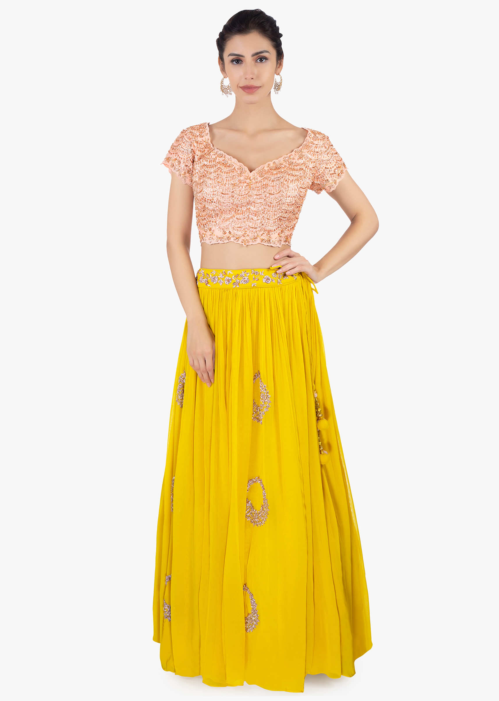 Canary yellow georgette skirt paired with a peach top and peach net dupatta
