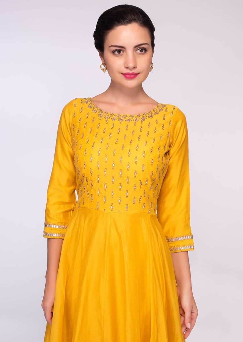 Canary yellow  silk anarkali gown paired with mint green  cotton dupatta in lace embroidery 