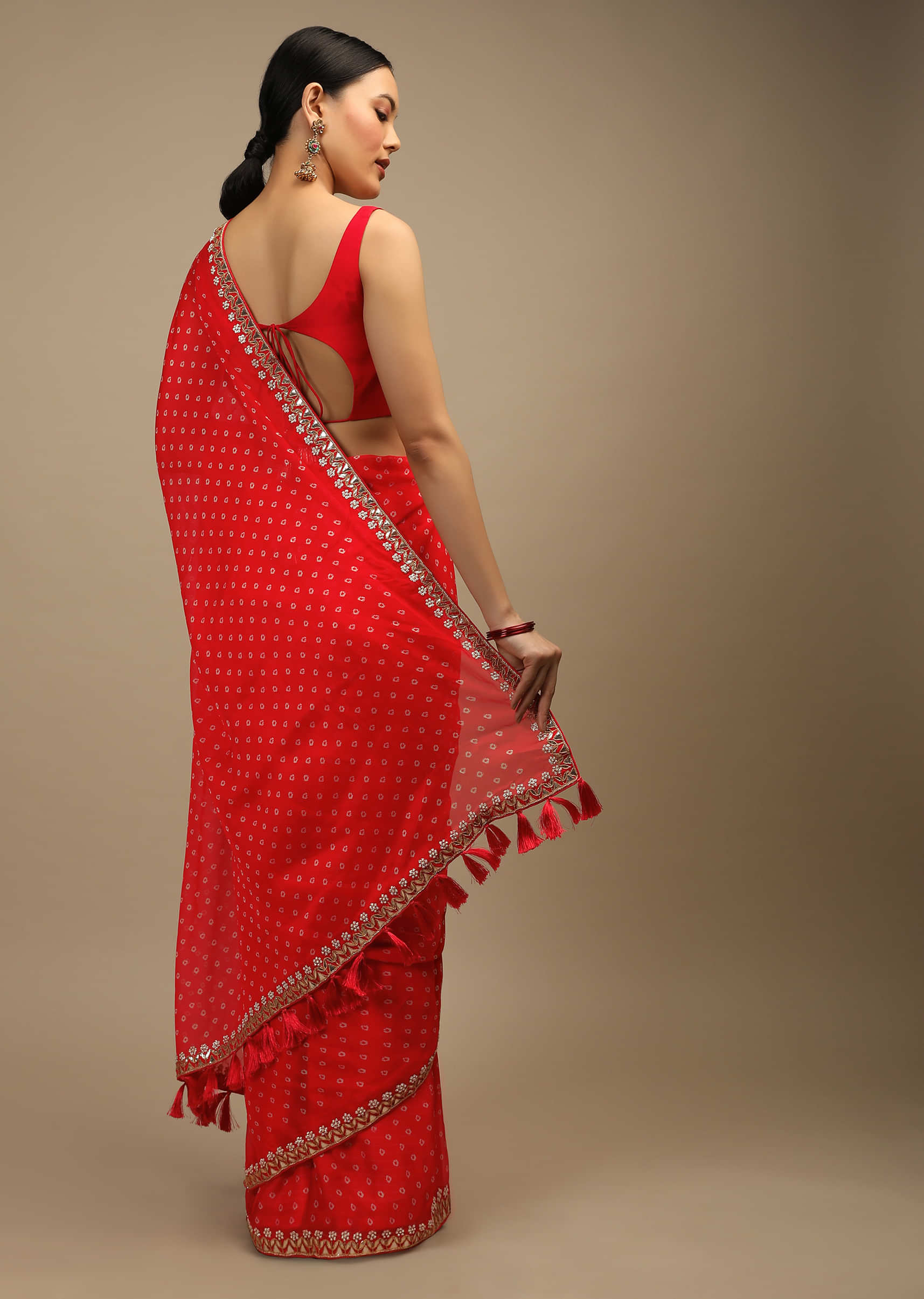 Coral Red Saree In Organza With Bandhani Buttis And Gotta Patti Embroidered Floral Motifs On The Border  