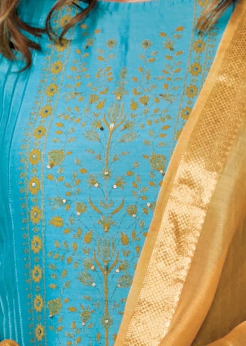 Cerulean blue unstitched suit adorn in foil printed placket in floral motif matched with mustard dupatta