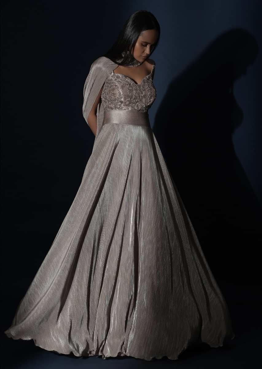 Champagne Gown In Crushed Shimmer With An Embellished Bodice Highlighting The Waistline And Fancy Cape