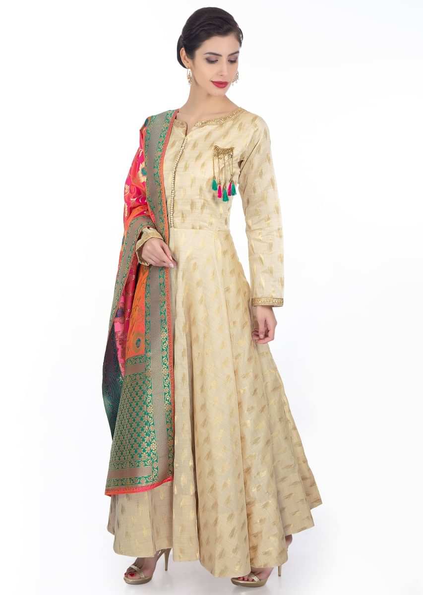 Chanderi silk cream anarkali dress paired with  coral brocade dupatta with teal border 